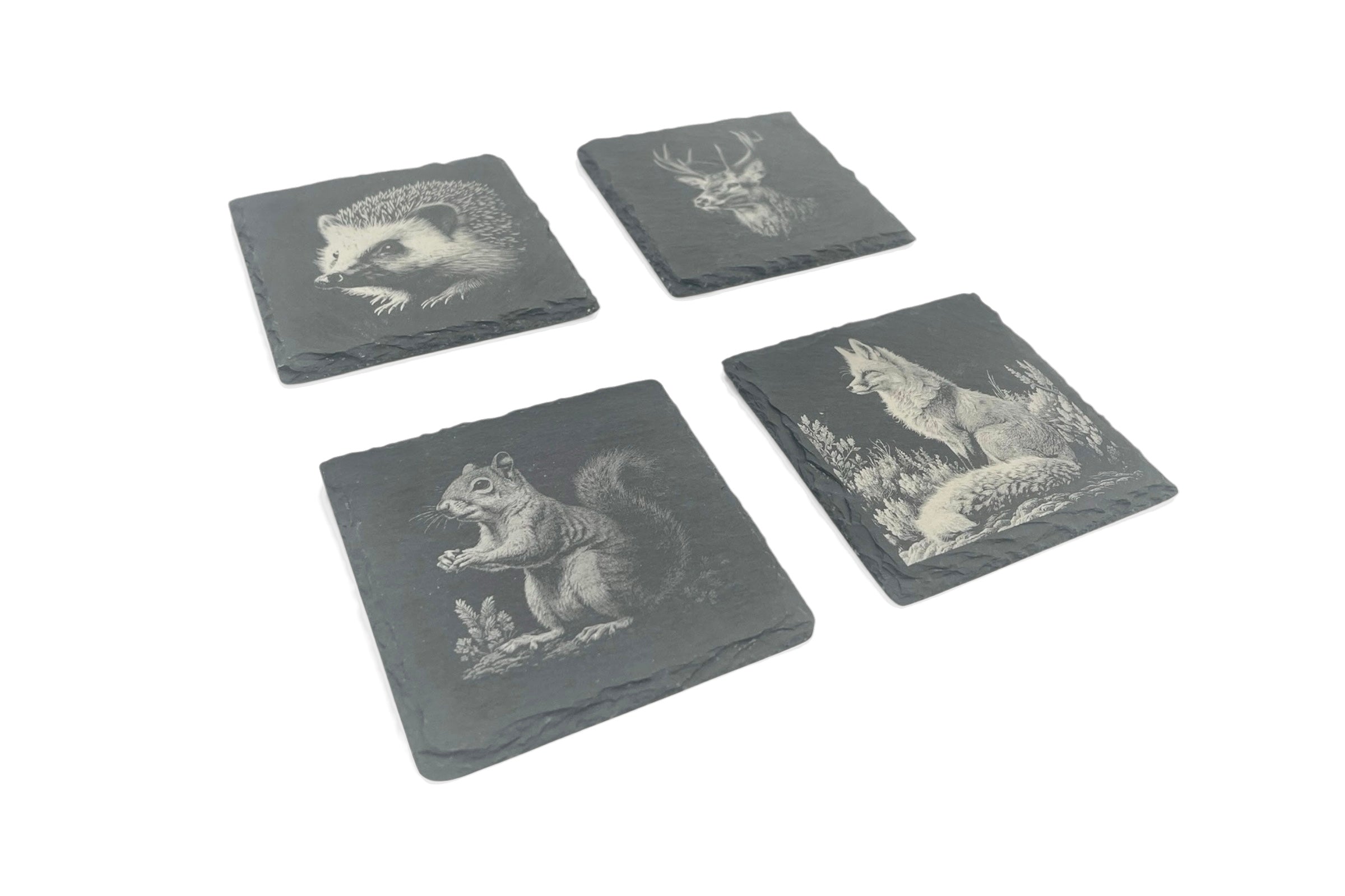Four slate coasters with UK wildlife images laser etched into the surface, on a white background.