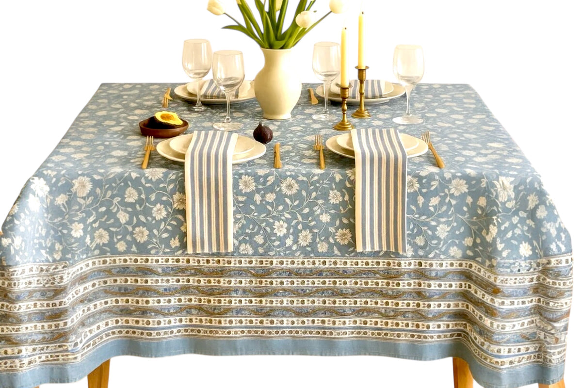 FINCHCRAFT Azure Vine cotton table cover with blue floral block-print pattern and decorative border on a dining table.