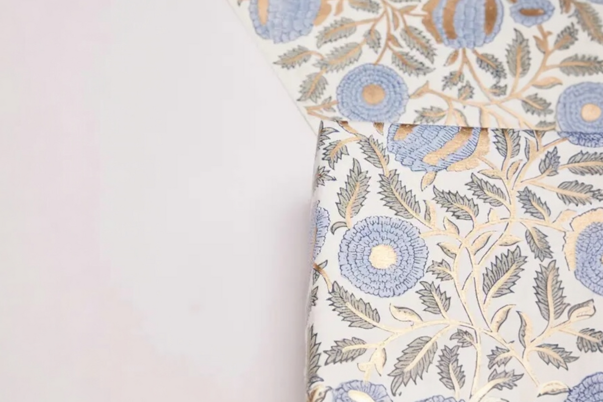 FINCHCRAFT hand block printed cotton wrapping paper with a blue and gold marigold floral motif on a white background.