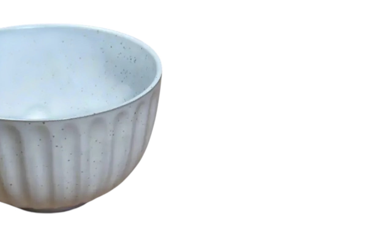 FINCHCRAFT speckled white glazed ceramic teacup with a softly ridged exterior and compact design.