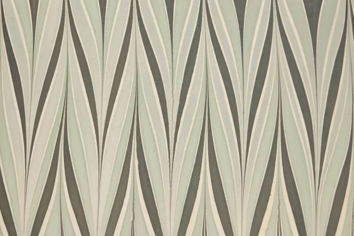 FINCHCRAFT hand marbled cotton wrapping paper featuring a stormy night pattern of flowing inky blue and charcoal waves.