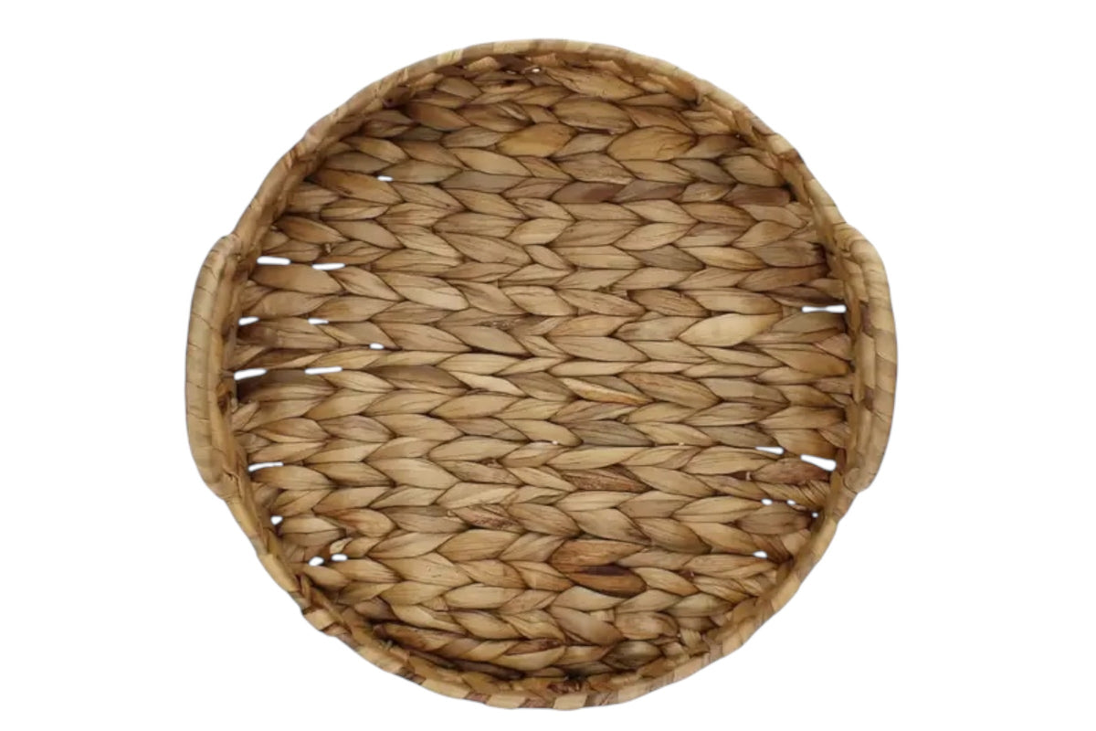 FINCHCRAFT circular tray woven from natural water hyacinth fibres with integrated handles, top-down view.