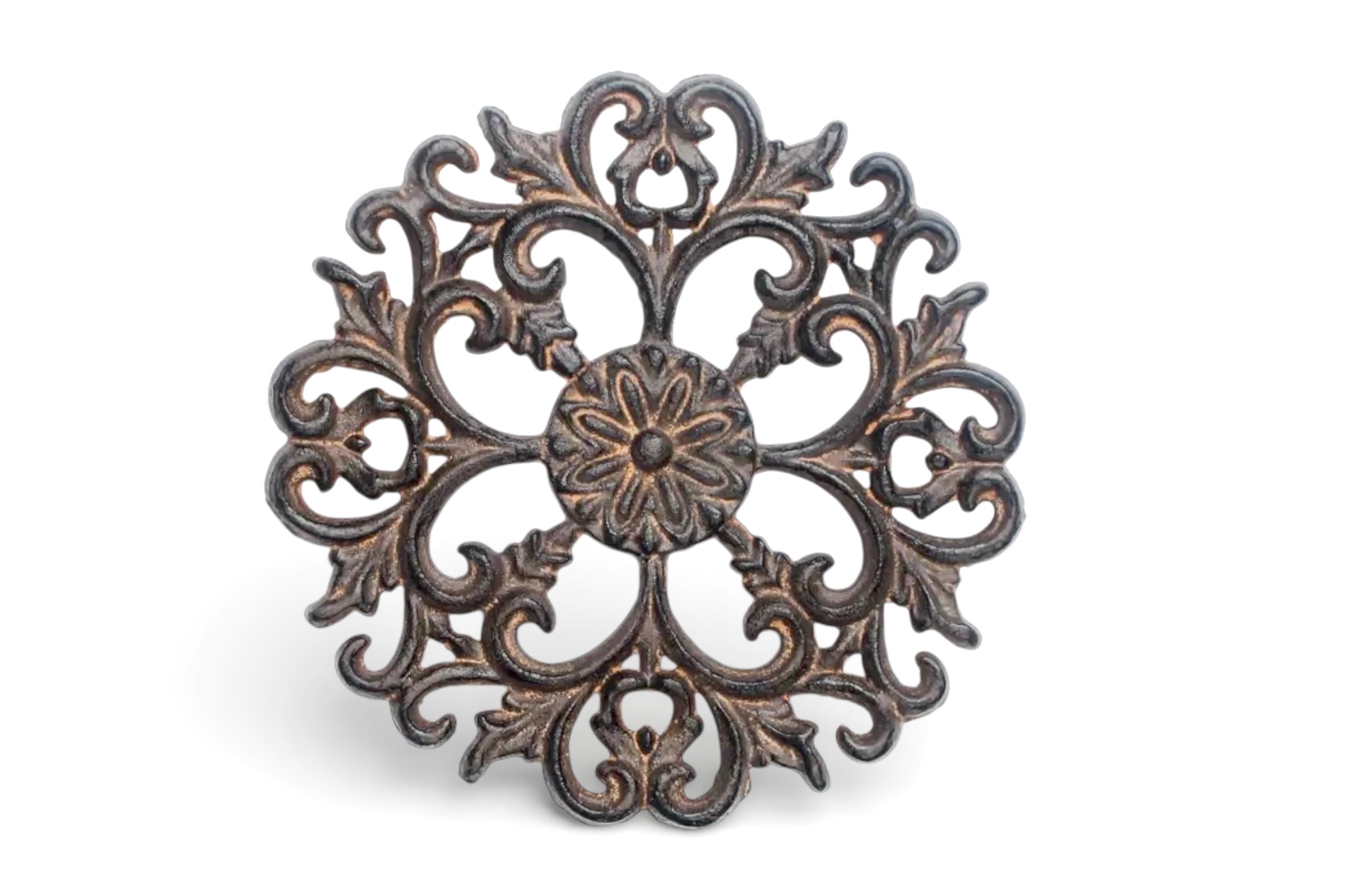 Acanthus design metal trivet pictured standing up on a white background.