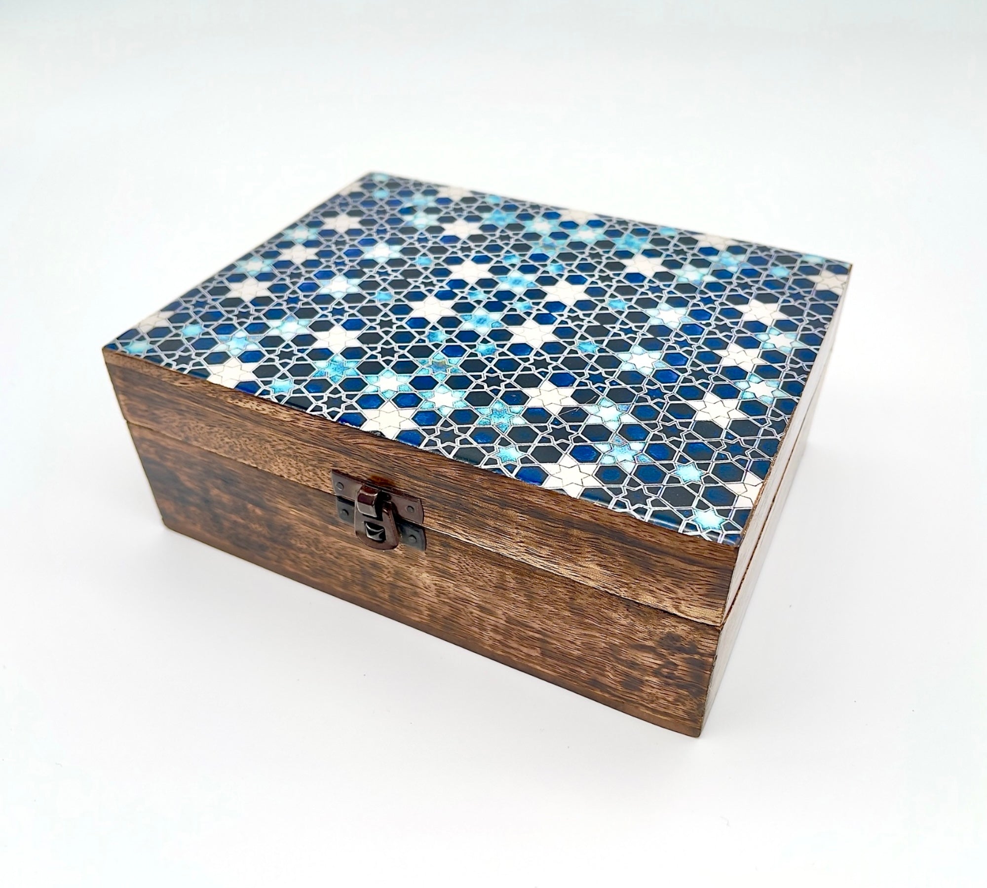 An closed wooden trinket box, with a blue enamelled lid with a geometric design, on a white background.