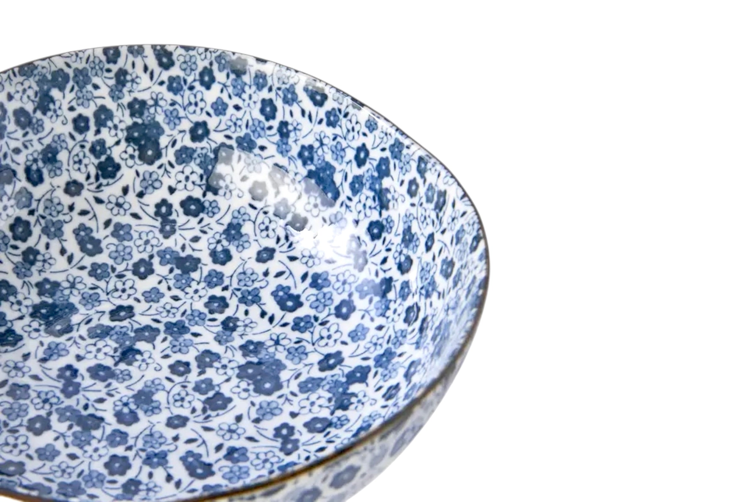 A cut off picture of a Japanese rice bowl with a blue daisy design on a white background.