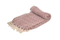 A burgundy handwoven cotton throw, folded, on a white background.