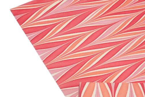Some handmade, candy stripe design wrapping paper on a white background.