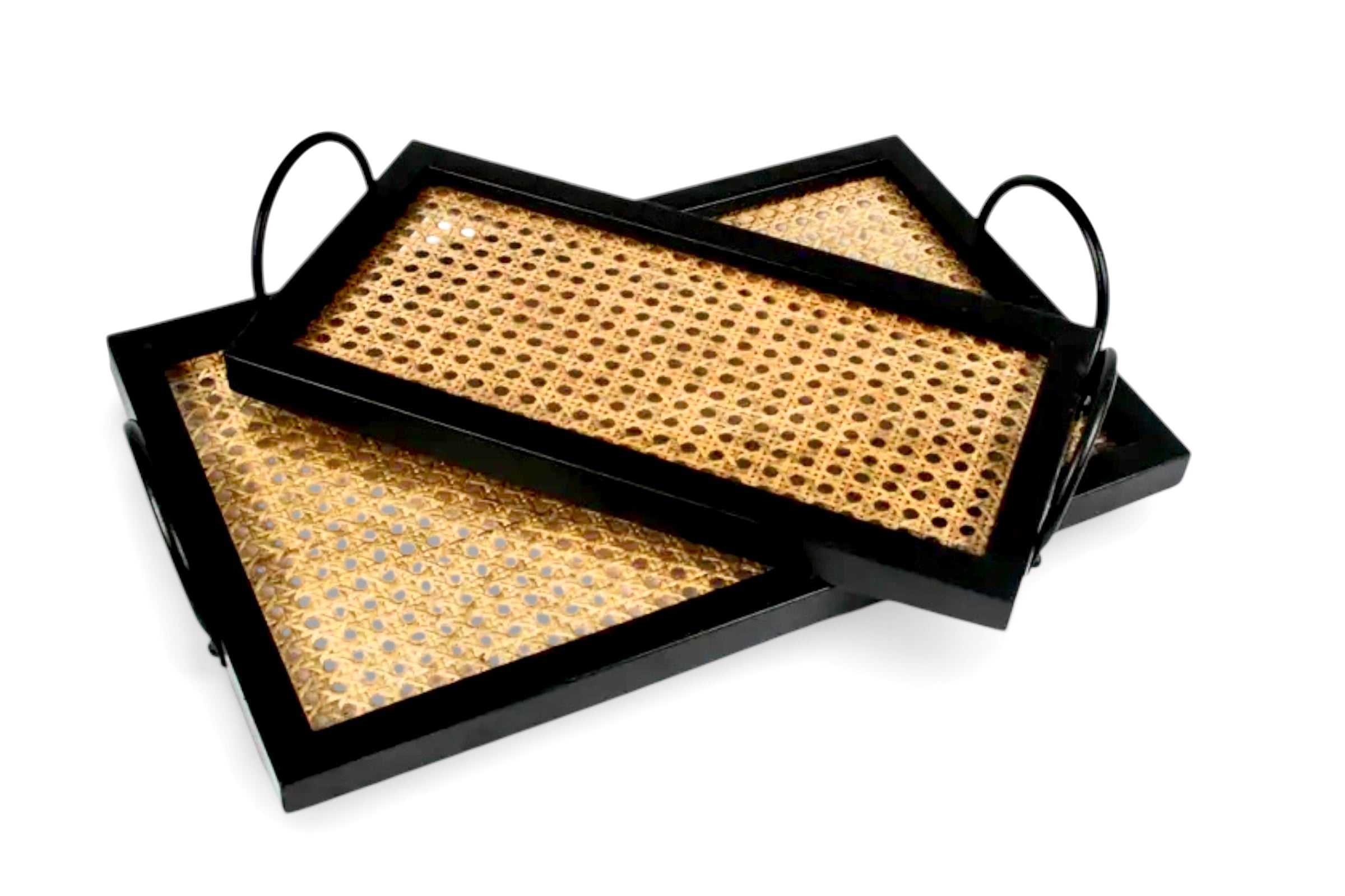 A set of 2 black wood and cane trays on a whitre background.
