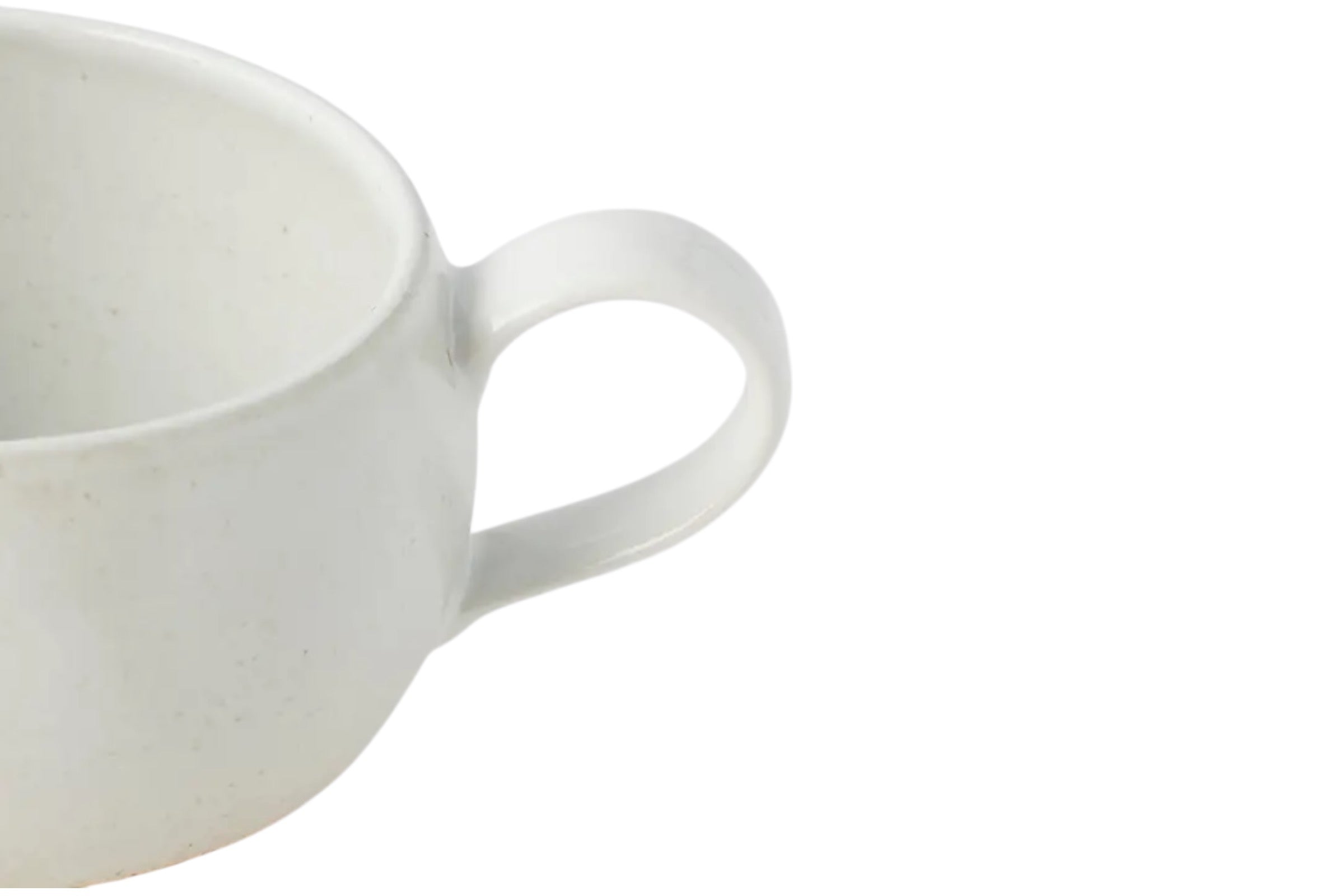 a cut off photo showing the handle of a Rounded White Earthenware Mug, on a whiote background.