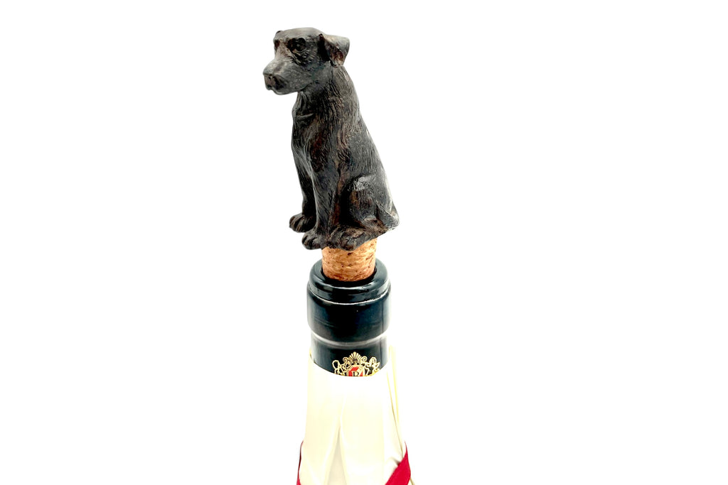 Dog-shaped bottle stopper on a wine bottle with a white background