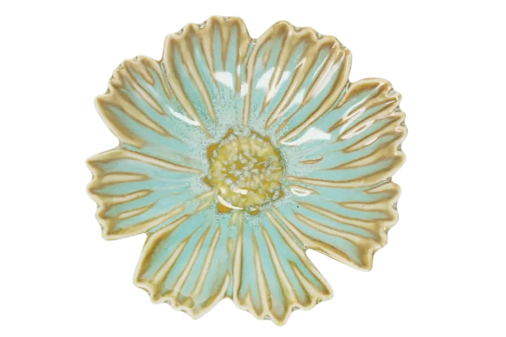 A small flower-shaped ceramic trinket dish set against a white background.