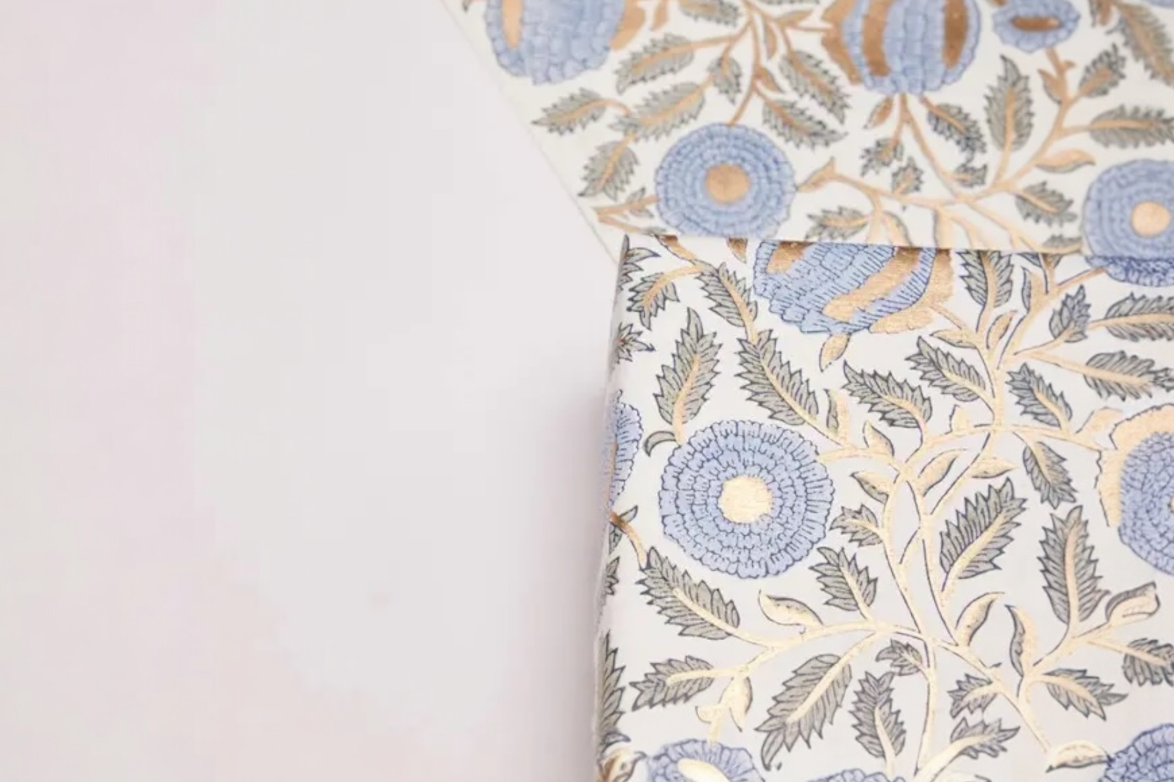 Some handmade Marigold Glitz wrapping paper on a white bakground.