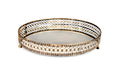 A round metal tray with a mirrored base and decorative detailing on a white background.