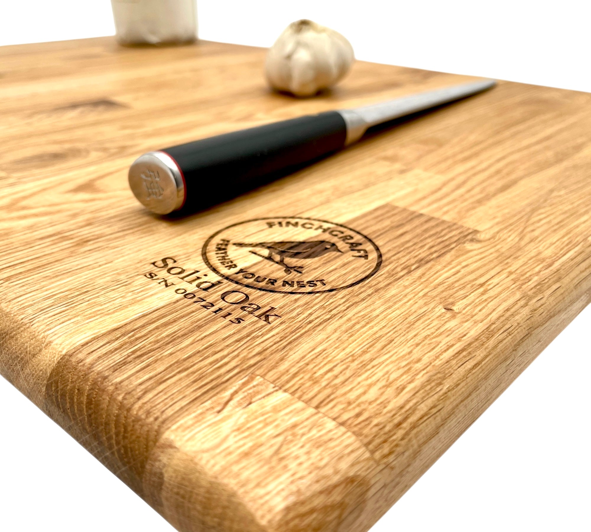 Large oak worktop saver with a knife and garlic and the engraved Finchcarft logo, on a white background.