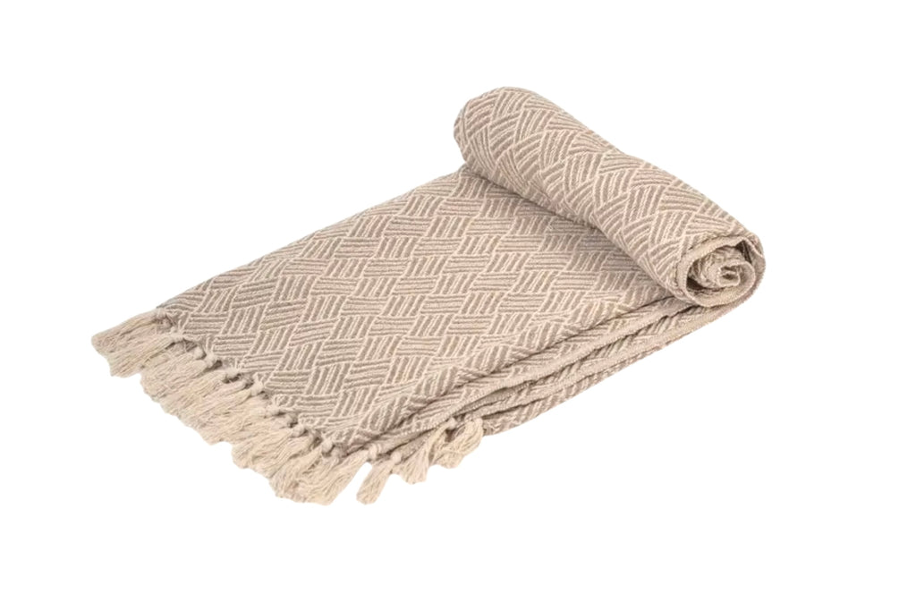 An oatmeal coloured handwoven cotton throw, folded, on a white background.