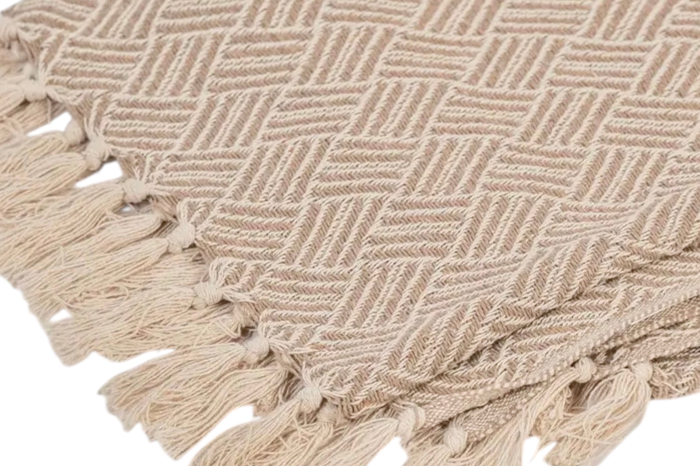 The corner of an oatmeal coloured handwoven cotton throw on a white background.