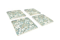 Set of four decorative coasters with floral patterns on a white background