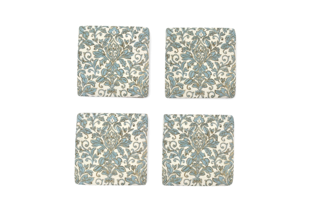 Four square coasters with floral pattern on a white background
