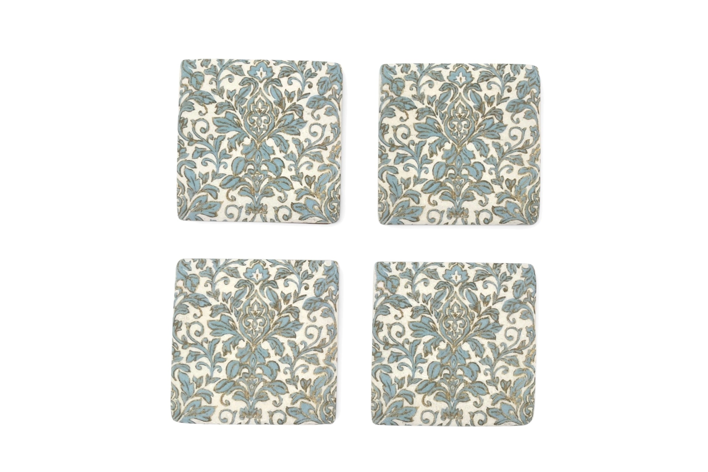 Four square coasters with floral pattern on a white background