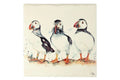 A 16 x 16cm ceramic trivet with a puffin illustration, set against. white background.