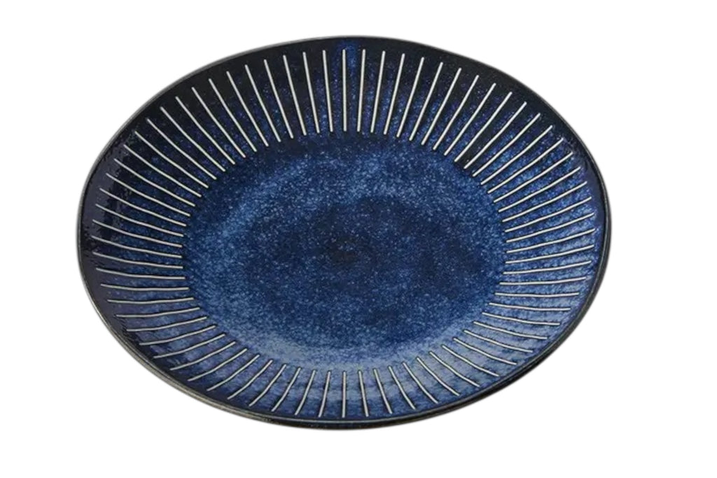 A 25cm porcelain dinner plate with an indigo glaze and fine embossed ridges. Set against a white background.
