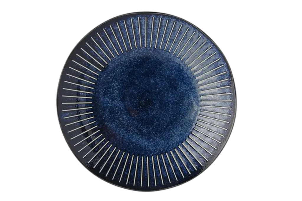A 25cm porcelain dinner plate with an indigo glaze and fine embossed ridges. Set against a white background.
