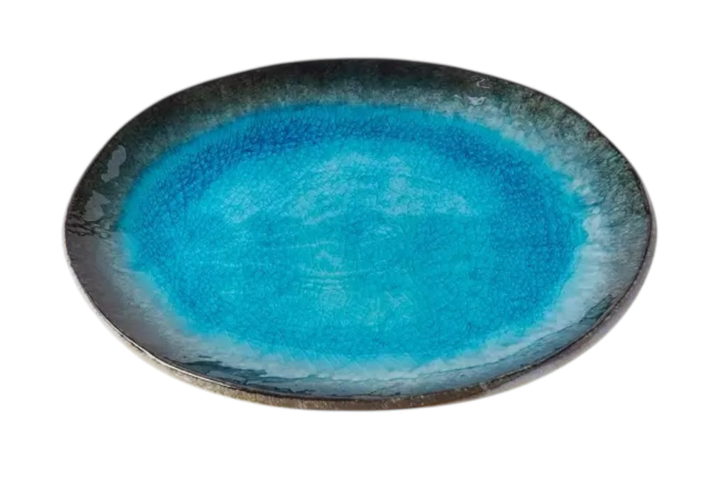 An oval porcelain plate with a soft sky blue glaze and organic outline, set against a white background.