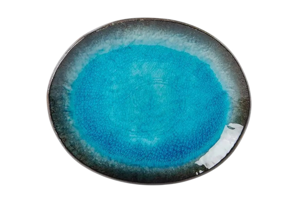An oval porcelain plate with a soft sky blue glaze and organic outline, set against a white background.