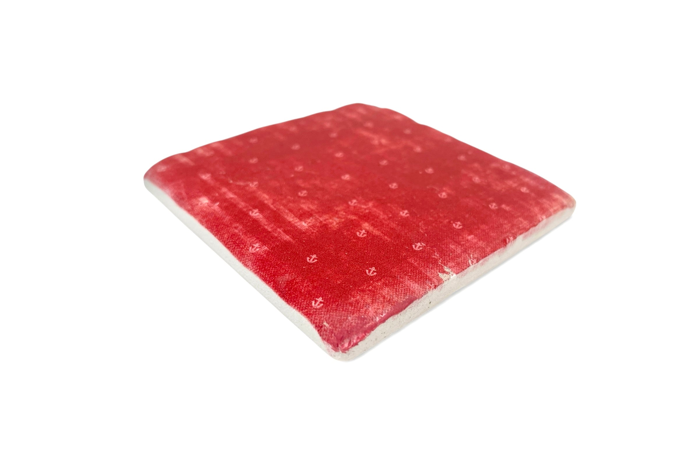 Red textured square coaster on a white background