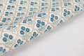 Some handmade, trellis indigo design wrapping paper on a white background.