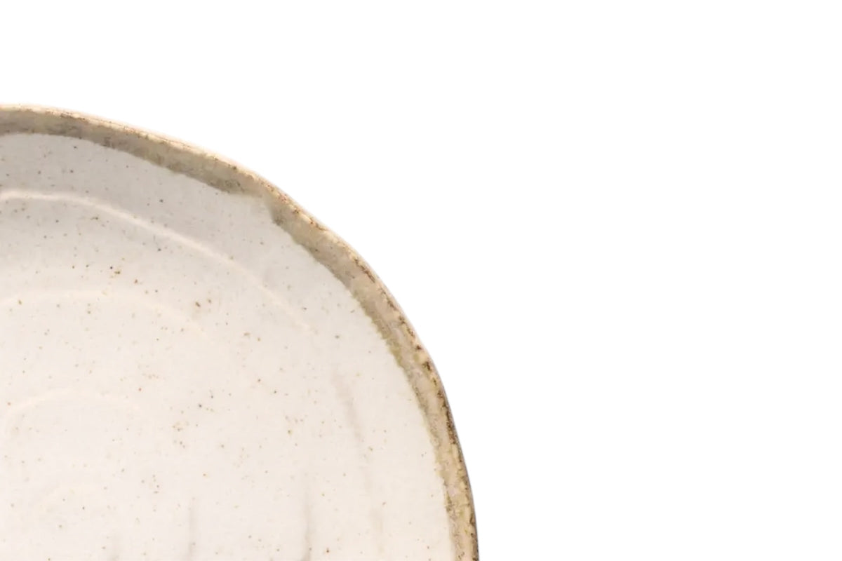 FINCHCRAFT flax-toned porcelain dinner plate with a softly faceted edge and subtle spiral relief texture.