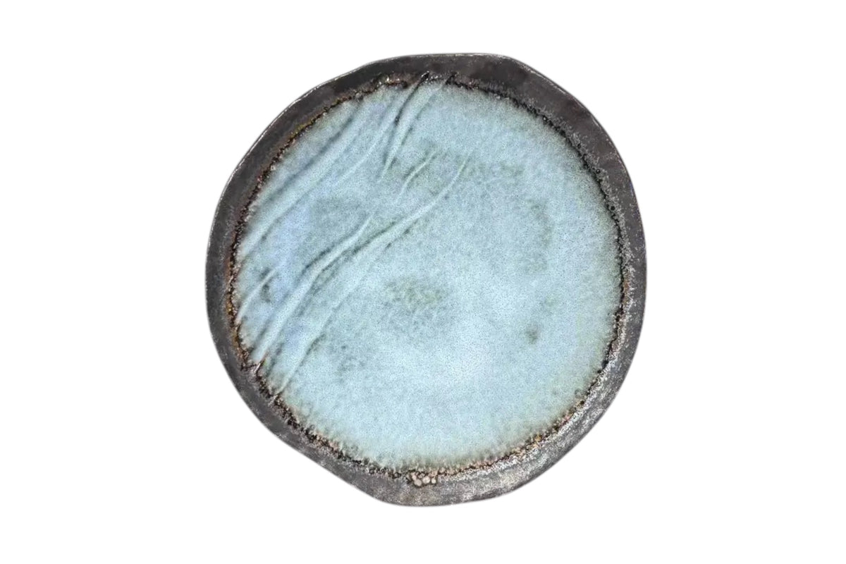FINCHCRAFT grey glazed stoneware plate with an irregular form and natural bisque edge, top-down view.