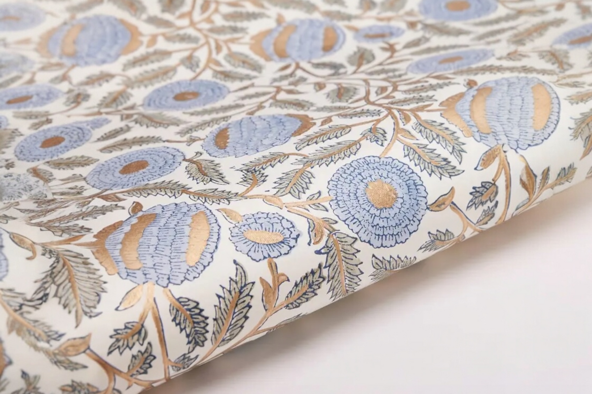 FINCHCRAFT hand block printed cotton wrapping paper featuring a blue and gold marigold floral motif on a white background.