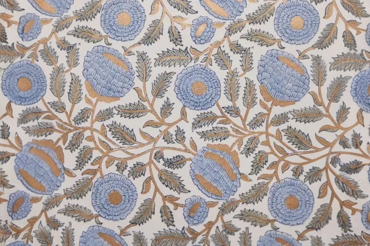 FINCHCRAFT hand block printed cotton wrapping paper featuring a blue and gold marigold floral motif on a light ground