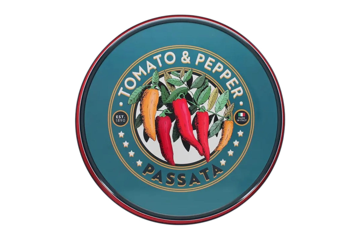 FINCHCRAFT round tinplate metal serving tray featuring a vintage tomato and pepper passata graphic on a teal background.