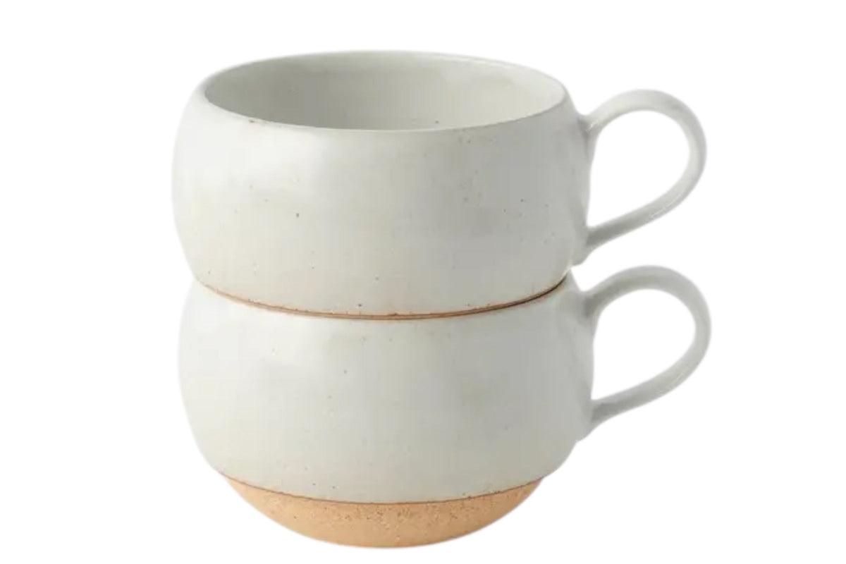 FINCHCRAFT rounded white earthenware mugs stacked, featuring a smooth glazed finish and exposed clay base.