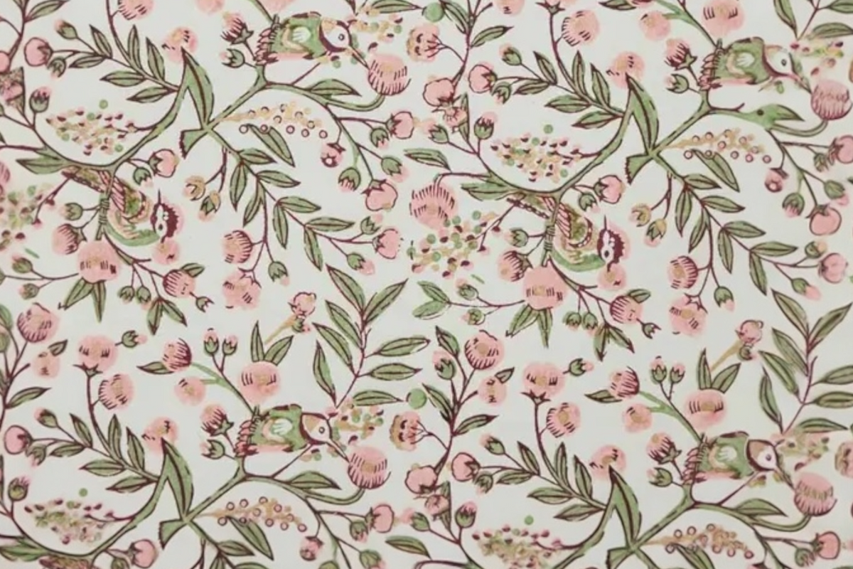 FINCHCRAFT blush pink and sage green hand block printed cotton wrapping paper with a whimsical songbird floral motif.