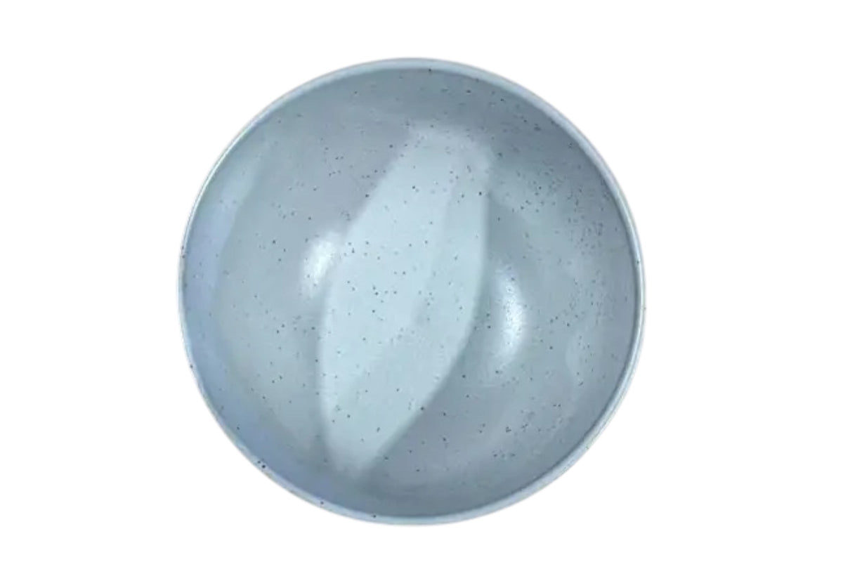 FINCHCRAFT speckled white ceramic teacup with a smooth glazed interior and ridged exterior, top-down view.