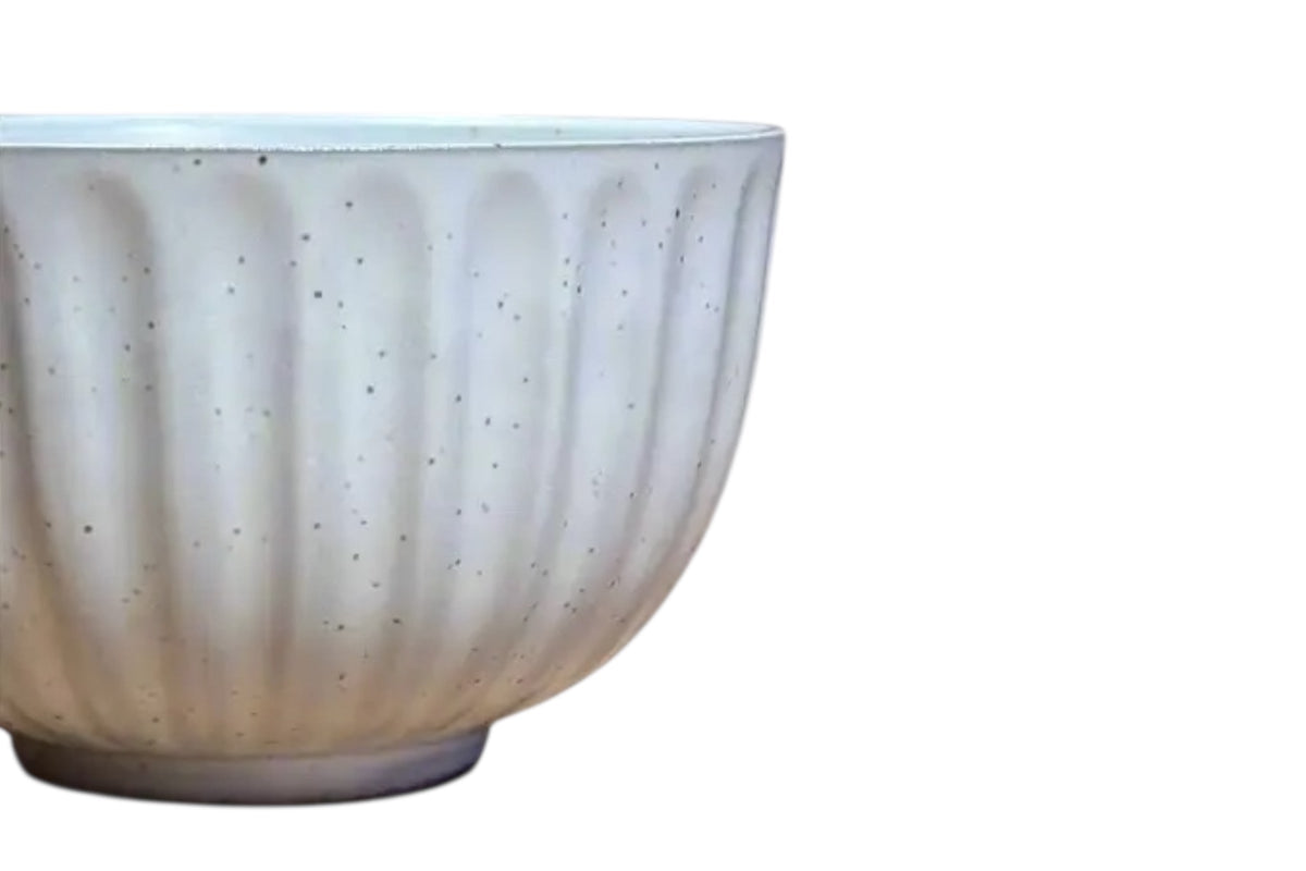 FINCHCRAFT speckled white ceramic teacup with a tactile ridged exterior and smooth glazed finish.