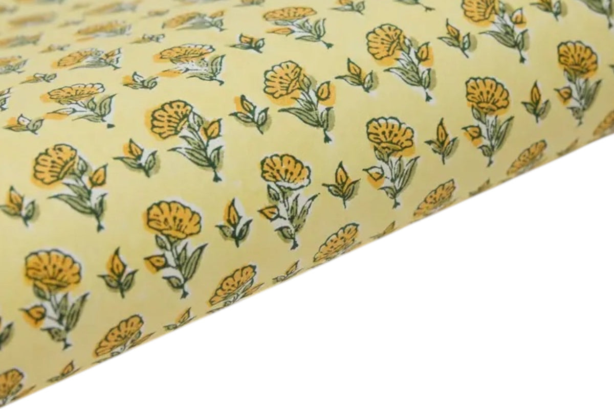 FINCHCRAFT sunshine yellow cotton wrapping paper with a hand block printed ditsy floral pattern.