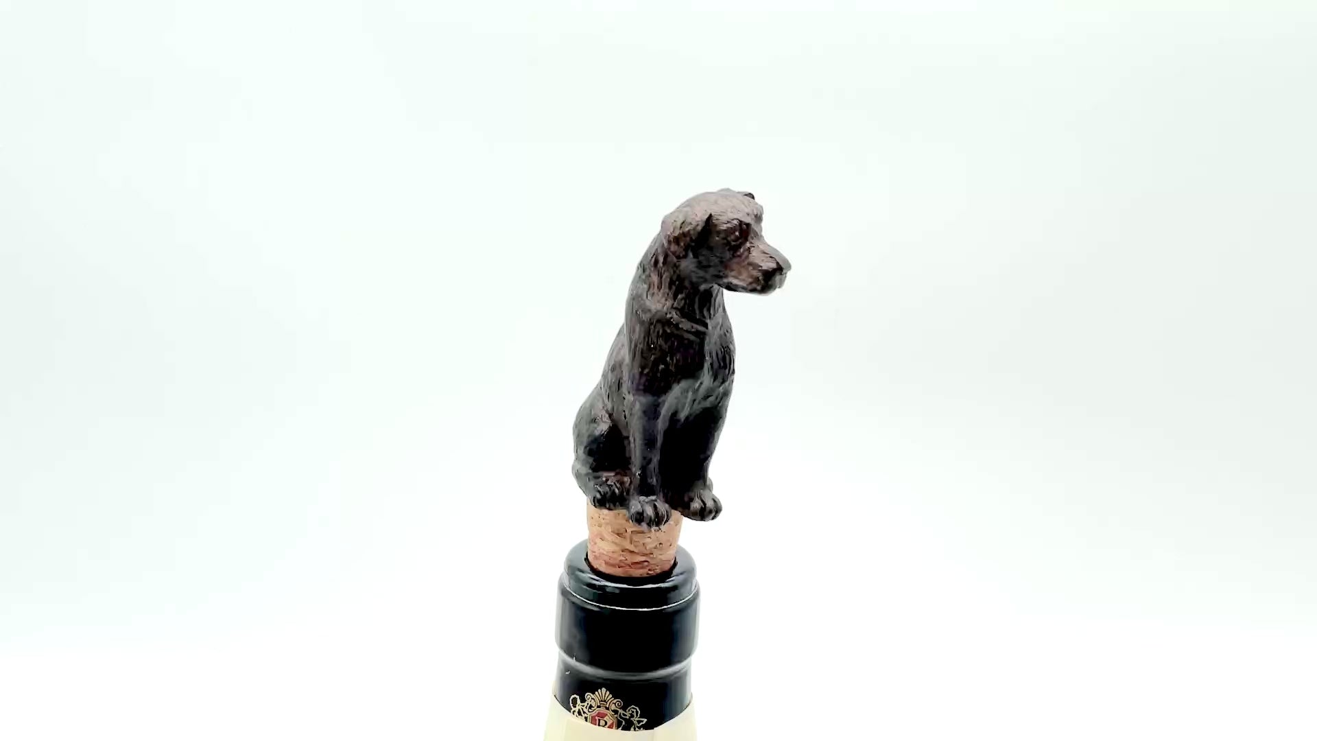 Video of a labrador shaped wine bottle stopper on a white background